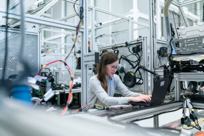 Operario revisando datos de producción en una fábrica digitalizada.